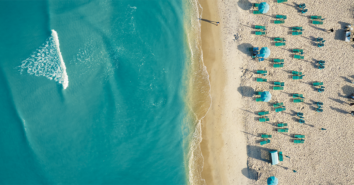 Aerial View of Beach with Turquoise Water and Sun Loungers