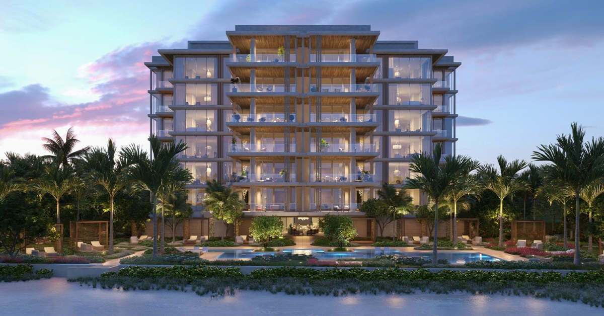 Oceanfront luxury residences with illuminated balconies at twilight