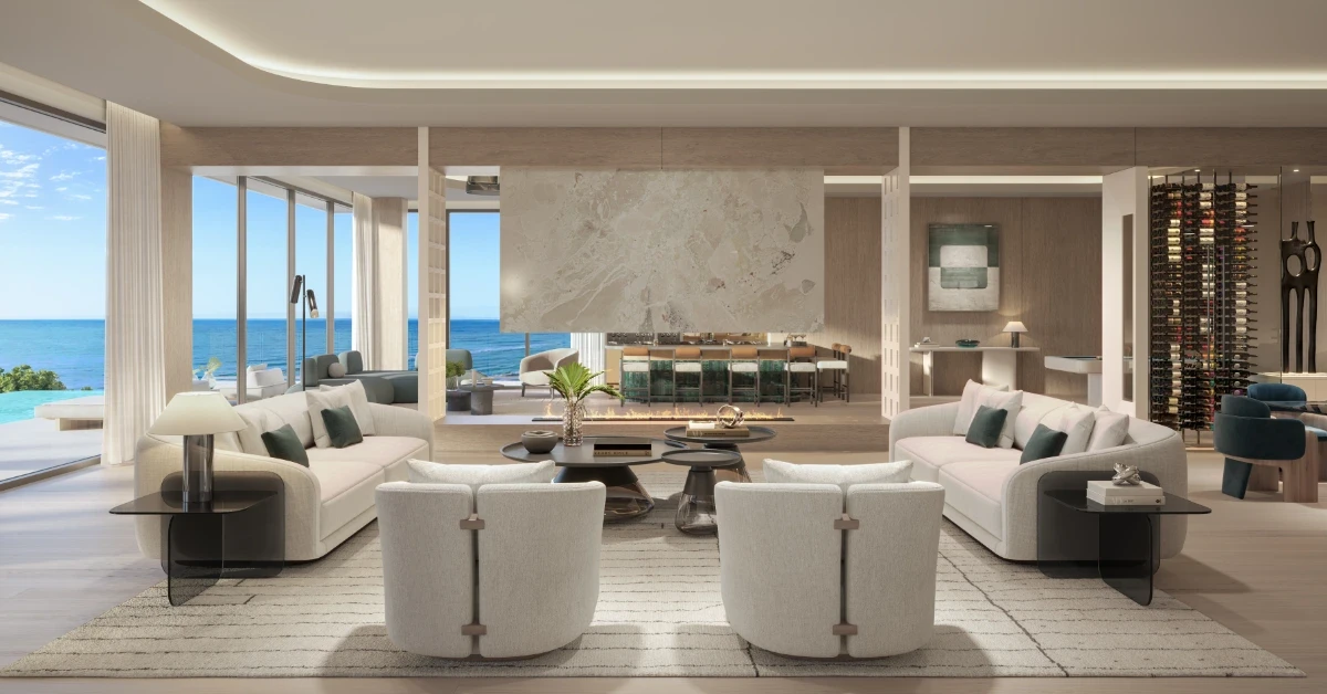 Contemporary oceanfront great room with curved sofas, fireplace, bar, and floor-to-ceiling windows.