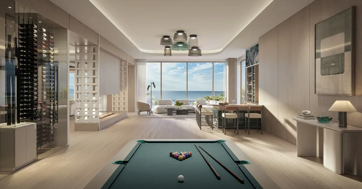 Luxury oceanfront game room featuring a billiard table, floor-to-ceiling views, wine cellar, and elegant modern furnishings in a high-end coastal residence.